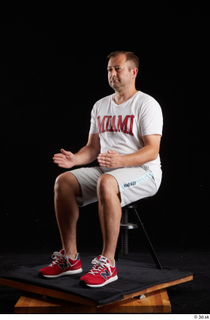 Louis  2 dressed grey shorts red sneakers sitting sports…